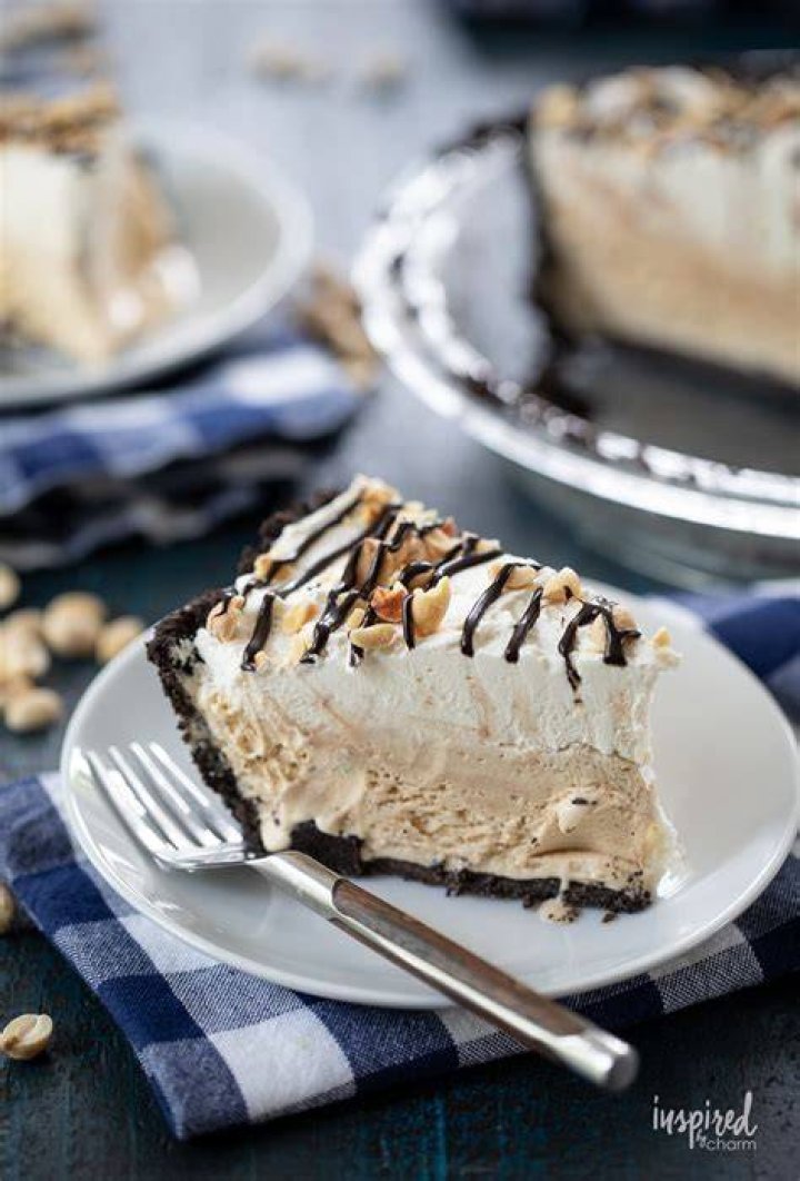 Slice of ice cream pie topped with caramel sauce and cookies.